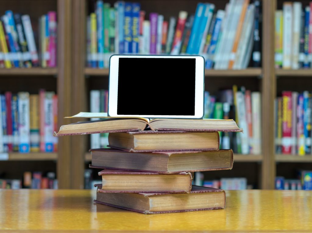  Book, Publication, Indoors, Library, Shelf, Furniture, Bookcase, Computer, Electronics, Tablet Computer, Computer Hardware, Hardware, Monitor, Screen, Table