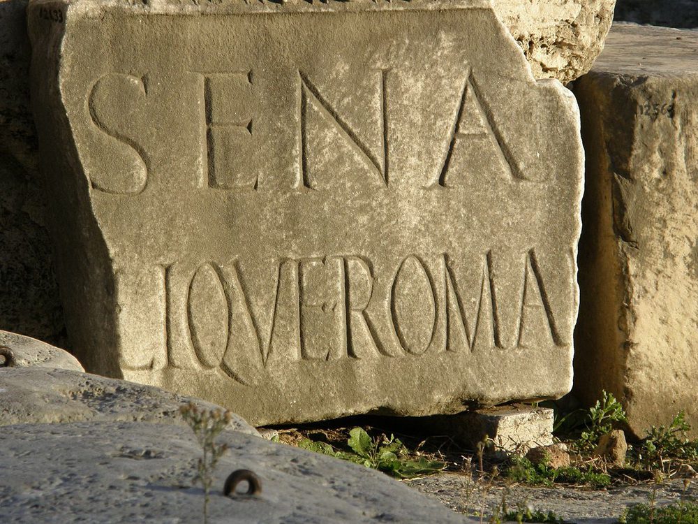 A fragment of a marble banner inscribed to the Senate of Rome lies in the Roman Forum.