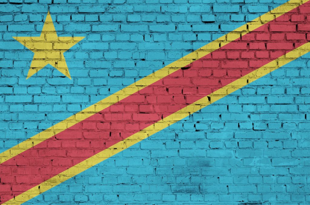 Democratic Republic of the Congo flag is painted onto an old brick wall