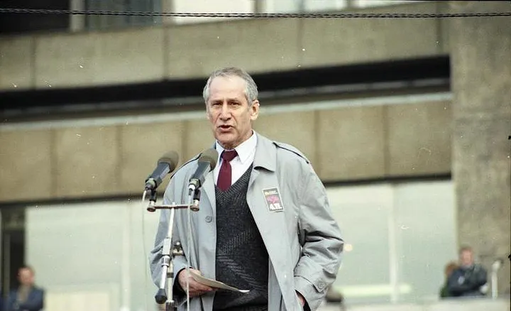 A man standing in front of microphones