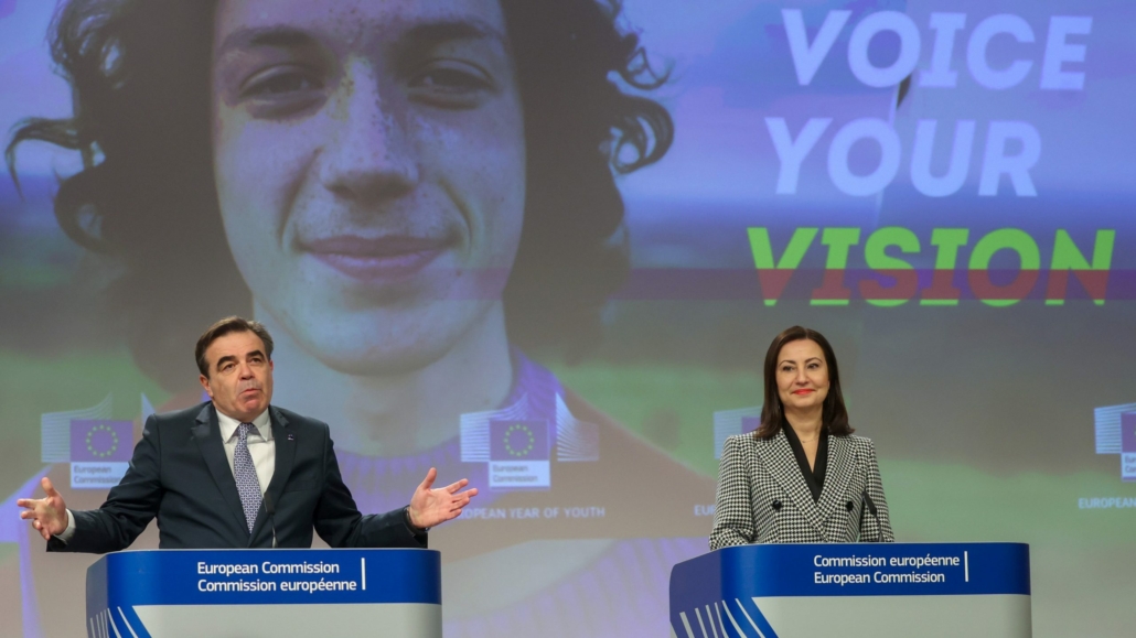 Who needs diplomats when you have Taylor Swift? 1 The photo shows two people in suits standing at podiums on a stage.