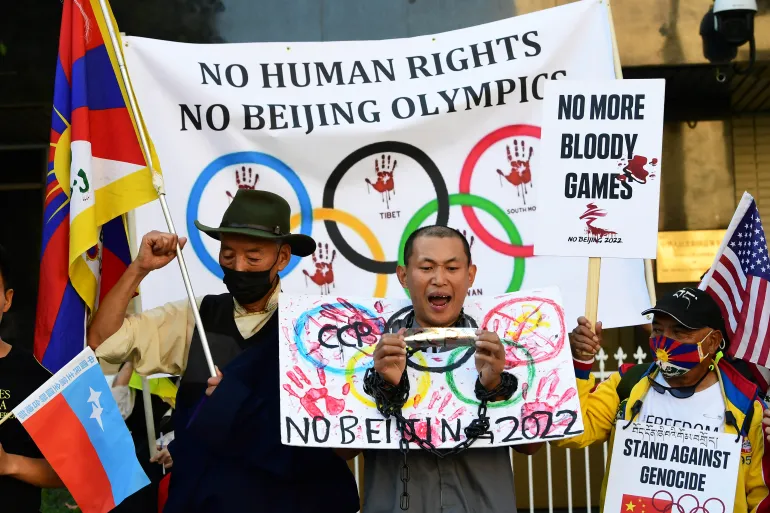 How sports diplomacy lost its innocence 2 The image shows a photograph of a group of protesters holding signs
