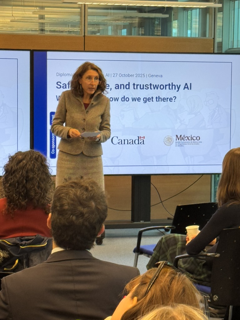 7228C60C-6C6A-4499-A80B-129682EB0052_1_105_c People, Person, Adult, Female, Woman, Crowd, Male, Man, Clothing, Coat, Audience, Formal Wear, Suit, Face, Head, Electronics, Screen, Architecture, Building, Classroom, Indoors, Room, School, Speech, Laurie Simmons