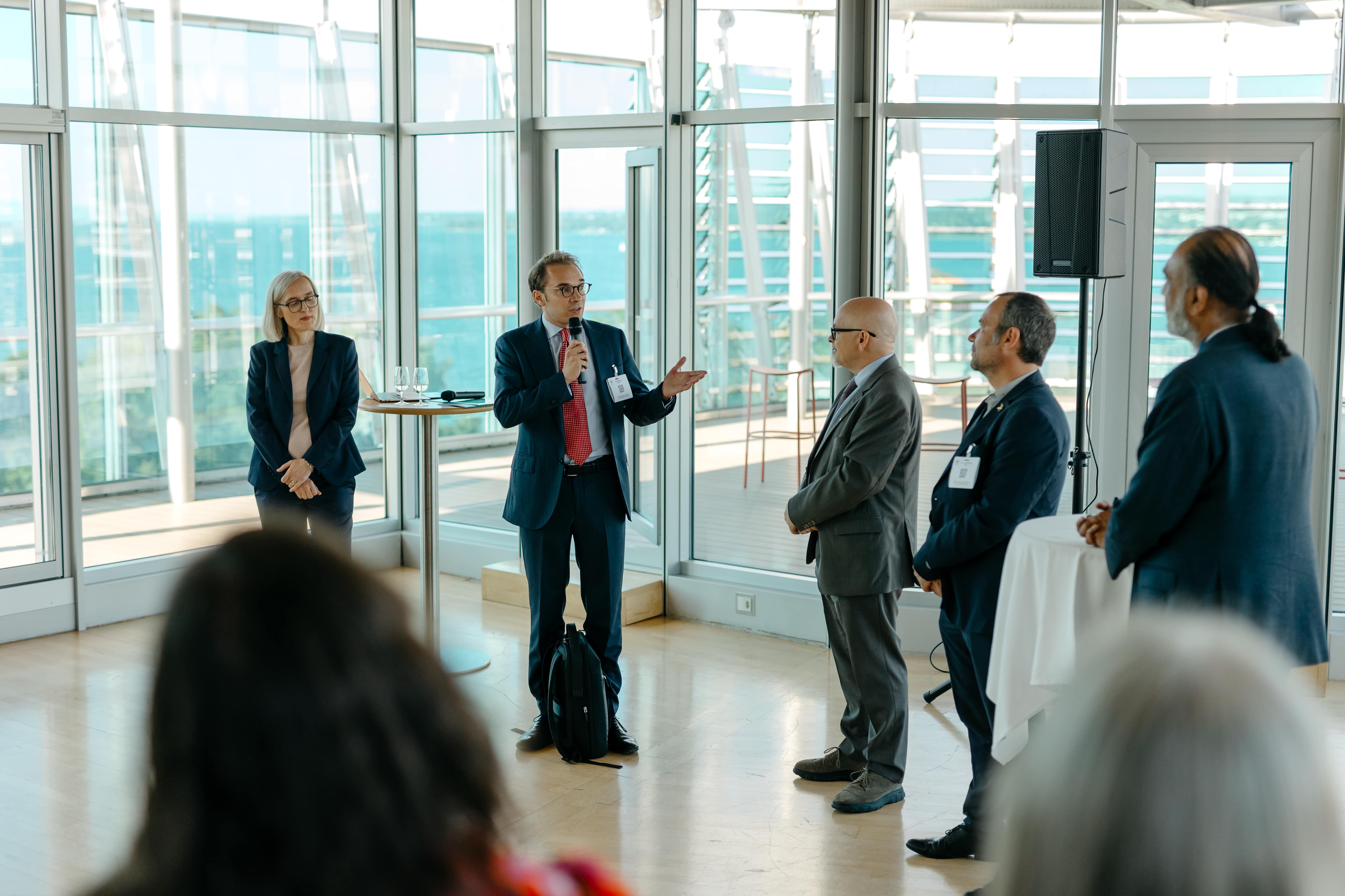 LAZA2164-min Adult, Male, Man, Person, Electronics, Speaker, Clothing, Footwear, Shoe, Female, Woman, Accessories, Glasses, Formal Wear, Suit, Backpack, Bag, Coat, Head, Face, Crowd, Ryan Merriman