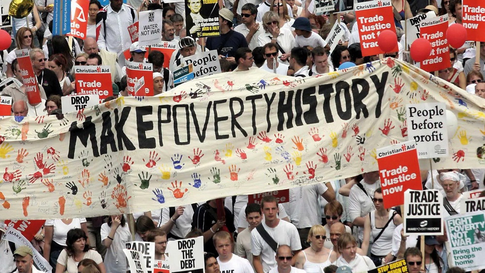 The impact of NGOs on international policymaking 2 The image shows a photograph of a group of protesters with a large banner with the text: Make Poverty History.