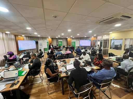 Diplo at Cabo Verde 10-12 Nov 2025 2 People, Person, Adult, Male, Man, Indoors, Chair, Furniture, Female, Woman, Architecture, Building, College, Computer, Electronics, Laptop, Pc, Classroom, Room, School, Crowd, Computer Hardware, Hardware, Monitor, Screen, Remote Control, Mobile Phone, Phone