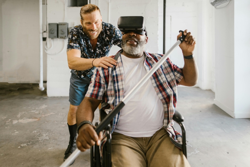 The image shows a man in a wheelchair wearing a virtual reality headset and holding a canoe paddle
