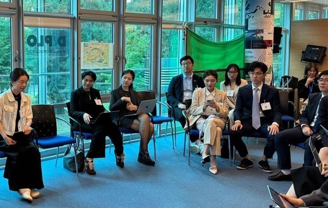 Accessories, Formal Wear, Tie, Clothing, Footwear, Shoe, Adult, Female, Person, Woman, Bag, Handbag, Male, Man, Chair, Furniture, Computer, Electronics, Laptop, Pc, Jewelry, Necklace, Glasses, High Heel, People, Computer Hardware, Hardware, Monitor, Screen, Crowd, Flag, Yoko Tawada, Jang Jin-young, Ding Yixin