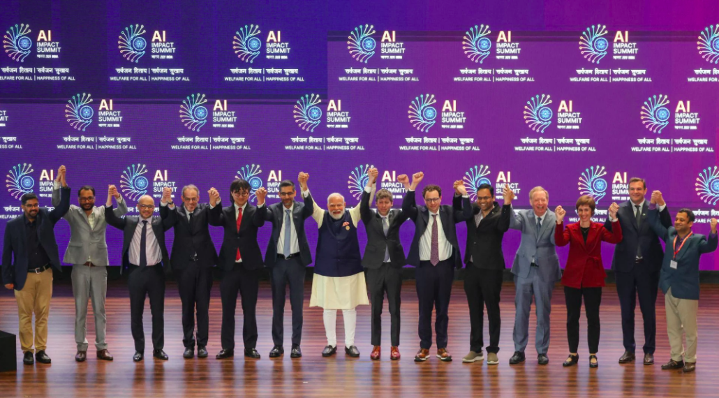 The image shows a photograph of several figures holding hands