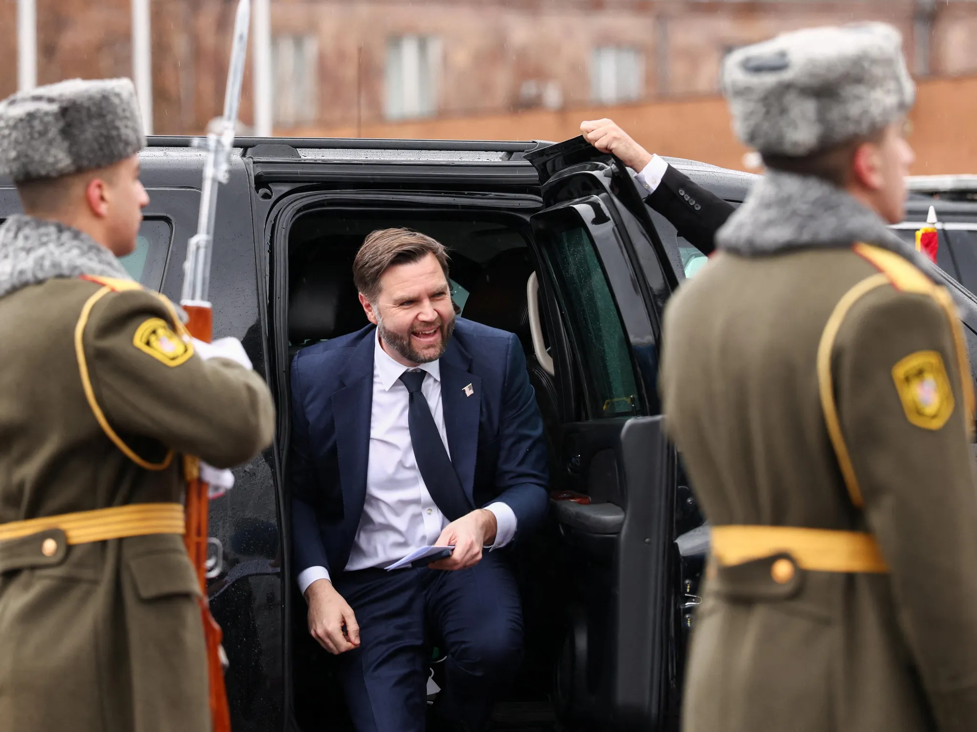 Corridors and calculations: America’s new diplomacy in the South Caucasus 2 The image shows a man in a suit sitting in the back of a car with other men in uniform