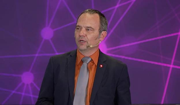  Purple, People, Person, Lighting, Blazer, Clothing, Coat, Jacket, Crowd, Light, Accessories, Formal Wear, Tie, Adult, Male, Man, Laser, Face, Head, Photography, Portrait, Electrical Device, Microphone, Suit, Audience, Lecture