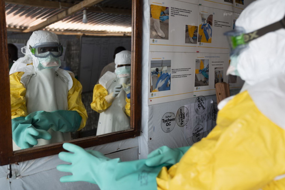 The uncertain ethics of Ebola treatments 1 The image shows a photograph of a person wearinga hazmat suit
