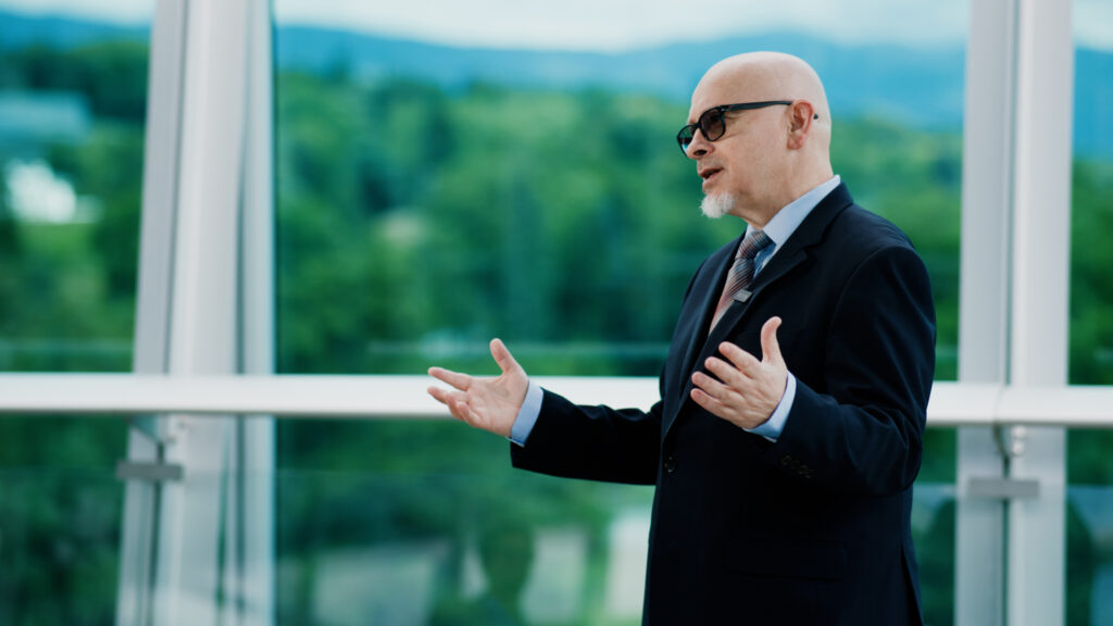 Geneva at the centre of AI governance: Where technology, diplomacy, and humanity converge 1 Adult, Male, Man, Person, Accessories, Glasses, Formal Wear, Tie, Body Part, Finger, Hand, Clothing, Suit, Coat