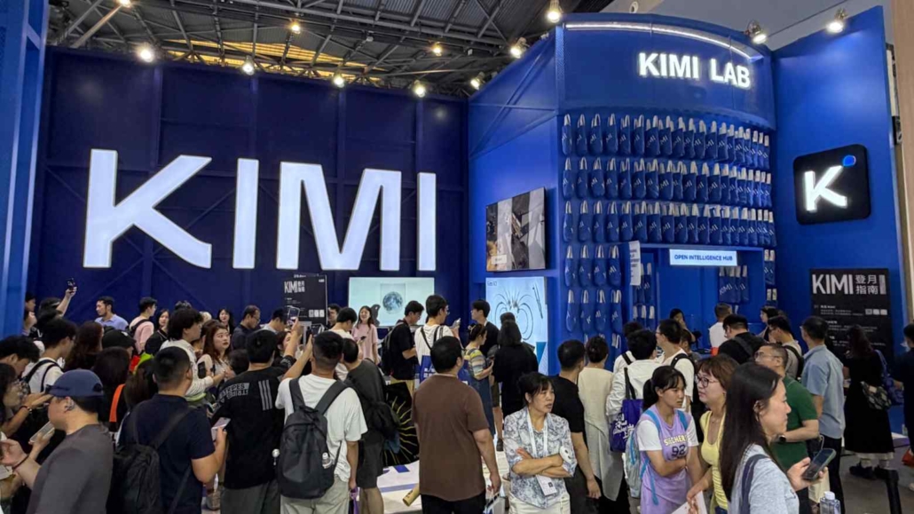 The image shows a photograph of people at a KIMI booth at the Shanghai AI Conference