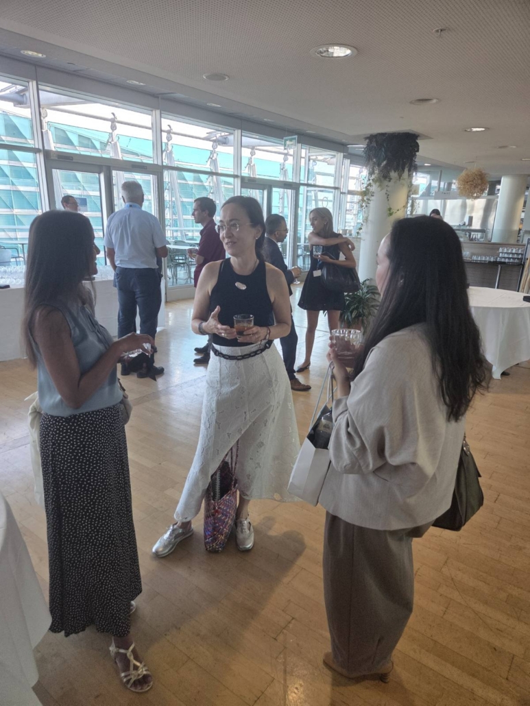 A photograph of conference attendees in discussion