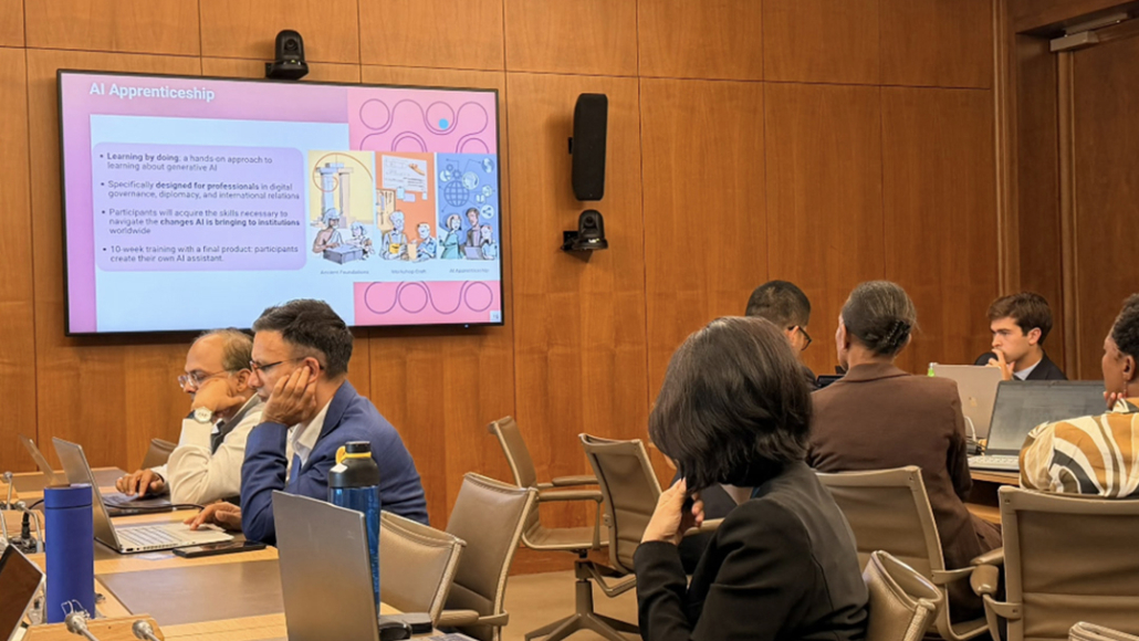  People, Person, Adult, Female, Woman, Crowd, Male, Man, Chair, Furniture, Audience, Face, Head, Indoors, Architecture, Building, Classroom, Room, School, Accessories, Glasses, Speech, Clothing, Formal Wear, Suit, Computer, Electronics, Laptop, Pc, Nadeem Malik, Scott Aukerman