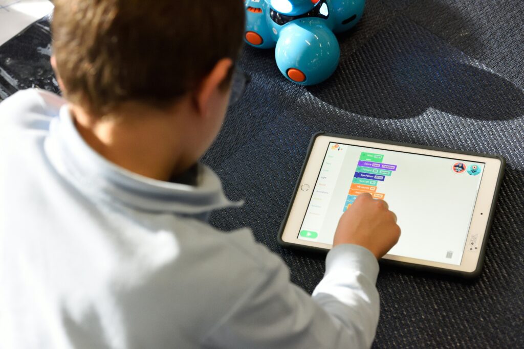 The image shows a child on a tablet