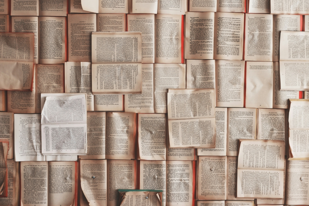 The image shows open books pinned to a wall