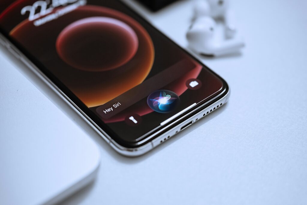 The image shows a phone with a notification saying 'Hey Siri'